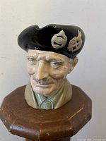 Front view of Royal Doulton Monty Toby mug character jug showing facial details and beret.