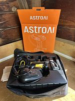 AstroAI air pump in carrying case with original box in background