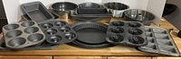 Photo showing the full assortment of baking pans including muffin pans, loaf pans, bundt pan, donut pan, pizza pan, and springform pan.
