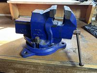 Side view of the blue Record SQ3 bench vise showing the vise jaws and quick adjust handle.