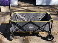 Open wagon showing the interior fabric and metal frame with yellow trim.