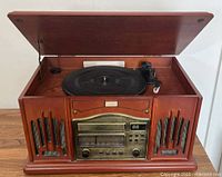Stereo console with open lid showing the record player turntable and front panel with radio and controls