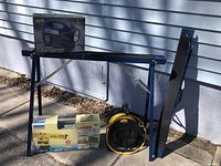 Photo shows the entire lot with two blue Mastercraft saw horses, MVP 5 in 1 Inflator/Deflator box, Powerfix Laser PLW 670 box, and yellow extension cord on reel.