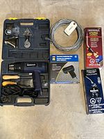 Mastercraft heat gun and accessories in a blue carrying case, dual heat soldering gun box, two propane torch kits boxed and coiled solder wire.