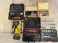 Overview of two rotary tools in cases with flexible shaft, staple gun, staples and accessory organizers