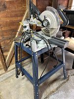Full view of miter saw on stand with extension cord draped