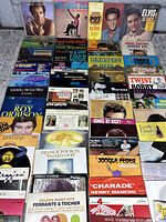 Photo of a variety of vinyl records from multiple artists including Herb Alpert, Elvis Presley, Paul Mauriat, Roy Orbison, and more