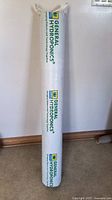 Rolled grow mat standing vertically against a wall, showing General Hydroponics branding.