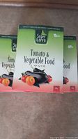 Five boxes of Super Green Tomato & Vegetable Food stacked showing front labels, each 2kg with NPK ratio 4-12-10.