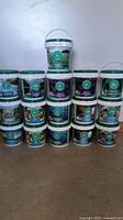 Overview of all 16 Gaia Green tubs stacked against wall