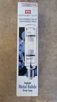 Front side of the boxed Hortilux Blue Metal Halide grow lamp showing brand name, product image, and basic product type.