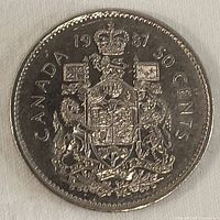 Reverse side of the 1987 Canadian 50 cent coin showing Canadian coat of arms and denomination.