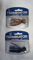 Two Terminator football jig fishing lures in factory sealed packaging, front view showing color and size label