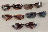 Top-down view of all 5 pairs laid out flat showing lens colors and frame styles