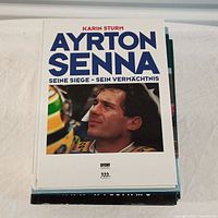 Photo of front cover of Ayrton Senna book with German text, showing a color image of Ayrton Senna.