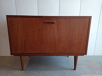 Front, closed view of the teak veneer cabinet