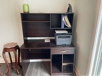 Photo showing a brown desk with a hutch, a drawer, and multiple compartments, including space for a printer and additional shelving.
