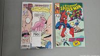 Photo showing Beavis & Butt-head comic on left and L'Étonnant Spiderman #5 comic on right, both in protective sleeves