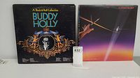 Buddy Holly and Supertramp LP albums front covers visible, showing Buddy Holly double album titled 'A Rock & Roll Collection' and Supertramp album with purple and orange sunset design