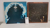Two vinyl albums showing Bob Dylan Greatest Hits and The Band album covers.