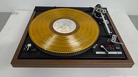 Top view of Dual Model 521 turntable with gold vinyl record on platter
