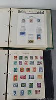 Two open stamp binders showing Australian stamps on detailed pages with text and images, and a page with assorted international stamps mounted.