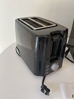 Black Betty Crocker toaster with two slots and multiple buttons and dial on the side.