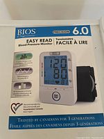 Front of box showing the BIOS Precision 6.0 blood pressure monitor with easy read display and features like 2 user memory, BP assessment, BIOS averaging.