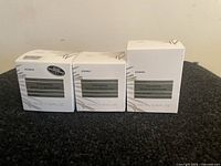 Three boxed Korres White Pine Volumizing Serum-in-Moisturizer products arranged side by side.