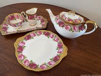 Oblique view showing teapot, rectangular tray with creamer and sugar bowl, and tea cake plate on table