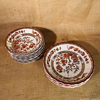 Photo showing two stacks of ceramic bowls with India Tree pattern: one stack of 9 smaller bowls about 5 inches diameter and another stack of 4 larger bowls about 6.5 inches diameter.