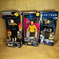 Lot of 3 Star Trek articulated action figures in original boxes including Data, Kirk, and Picard shown together.