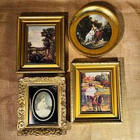 Four gilt framed prints placed on burlap background showing different styles and shapes: two rectangular landscape prints matching in size, one circular Rococo style print, and one ornate rectangular print with oval black matting with girl portrait.