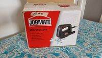 Original cardboard box with red and white design showing image and brand of Jobmate jig saw.