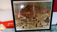 Front view of framed print showing winter village scene and Lot sticker