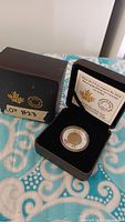 Canadian $5 silver coin with tulip design in clear capsule inside black velvet-lined case and outer box labeled LOT #23.