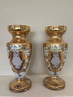 Front view of both vases showing gold overlay and floral design