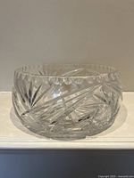 Side view of the medium clear crystal glass bowl showing detailed cut starburst and fan patterns.