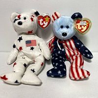 Two USA themed TY Beanie Babies standing upright showing front details and tags