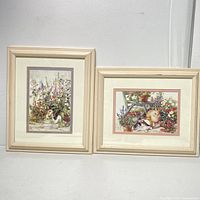 Two framed prints side by side against a white background, showing rabbit and floral designs
