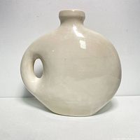 Front view of the large ceramic jug style vase showing its narrow body, circular shape, and integrated handle.