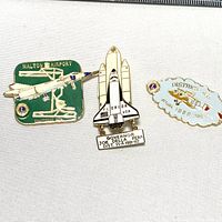 Three vintage aviation pins shown together on white backdrop. Pins depict Milton Airport Ontario, Florida space shuttle with governor plaque, and Ottawa District 1980.