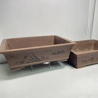 Two vintage Bonzi planters shown side by side, one elevated to show design and shape