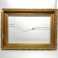 Front view of the vintage gold frame showing ornate border design and hanging wire.