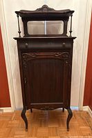 Full front view of cabinet showing drawer, door, carved accents, and cabriole legs