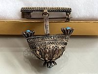 Front view of Yemenite silver filigree brooch showing intricate wire work and turquoise stones