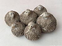 Cluster of six bird forms viewed from slightly above