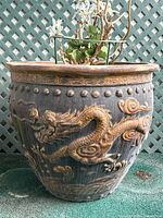 Front view of planter showing raised dragon relief design and overall shape