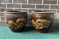 Front view of both planters on green carpet against brick wall