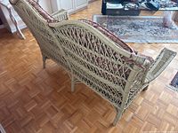 Side view of loveseat showing woven frame, armrest and cushion
